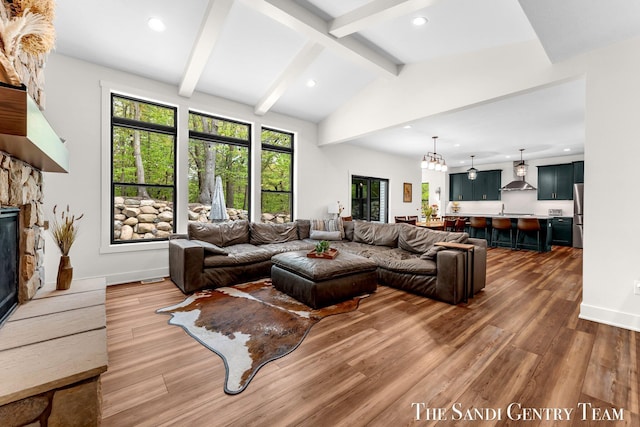 living room with wood finished floors, a fireplace, recessed lighting, and baseboards