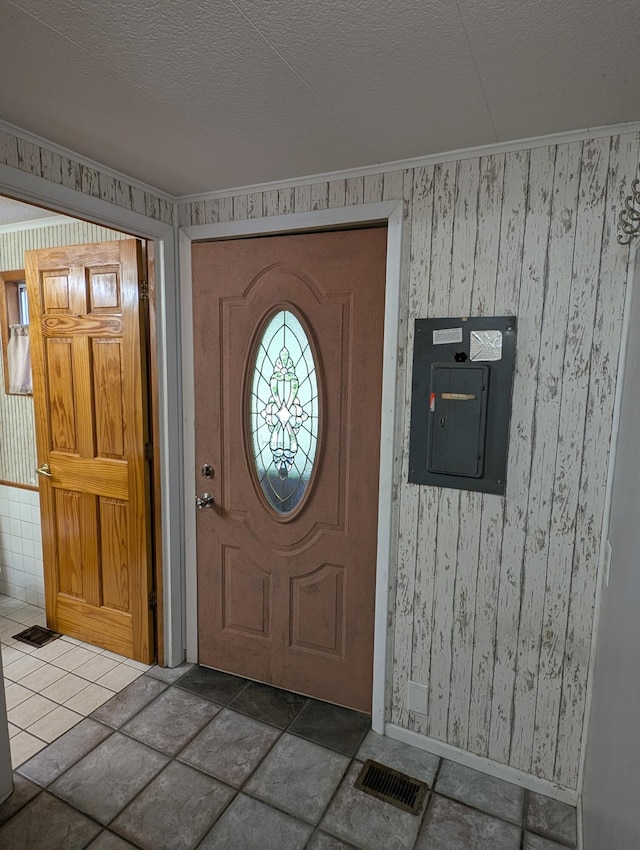 602 Fourth St, Ludington, MI 49431 - entrance foyer featuring electric panel, a textured ceiling, and baseboards