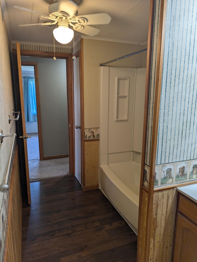 602 Fourth St, Ludington, MI 49431 - bathroom featuring wood finished floors, shower / bathtub combination, a ceiling fan, vanity, and ornamental molding