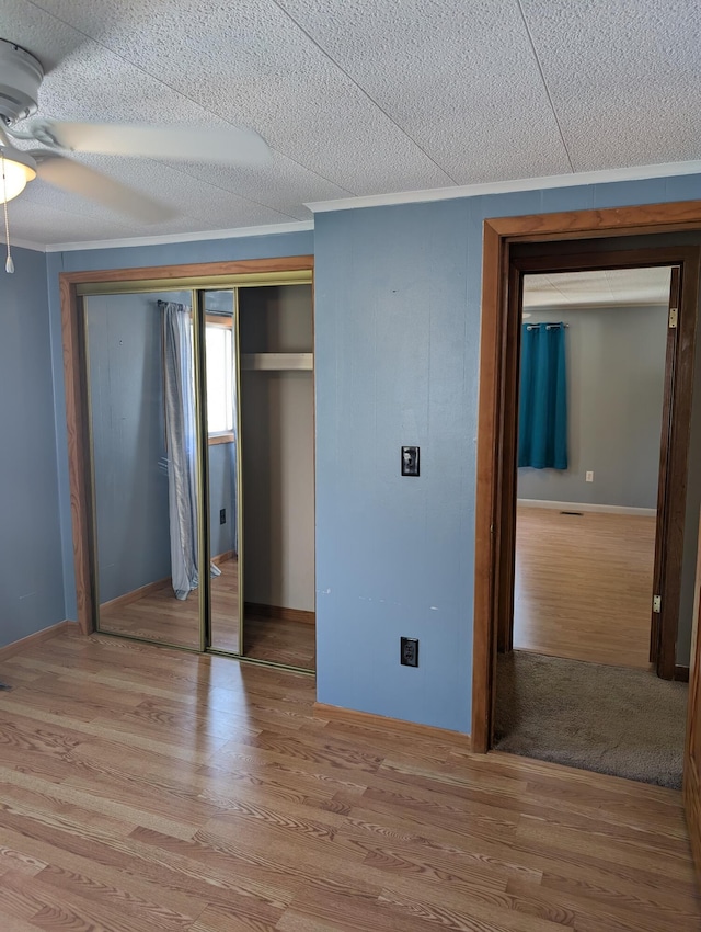 602 Fourth St, Ludington, MI 49431 - unfurnished bedroom featuring wood finished floors, a closet, and baseboards