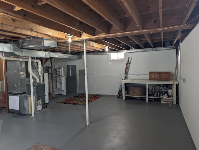 602 Fourth St, Ludington, MI 49431 - unfinished basement featuring heating unit and concrete block wall