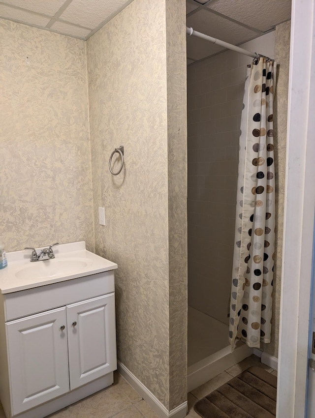 602 Fourth St, Ludington, MI 49431 - full bathroom featuring wallpapered walls, a stall shower, vanity, baseboards, and tile patterned flooring