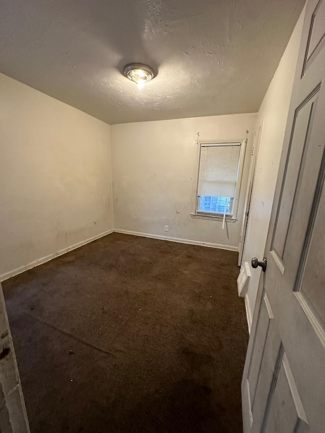 19731 Harlow St, Detroit, MI 48235 - empty room featuring baseboards and dark colored carpet