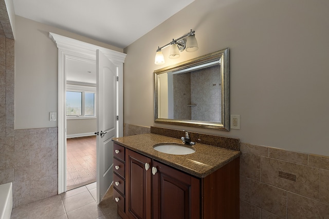 66701 Notre Dame Blvd, Washington, MI 48095 - full bath featuring tile walls, vanity, a wainscoted wall, tile patterned floors, and a bath