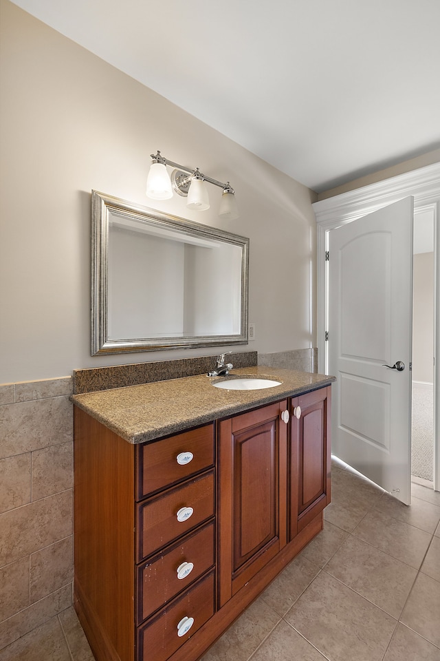 66701 Notre Dame Blvd, Washington, MI 48095 - bathroom featuring vanity, tile patterned floors, a wainscoted wall, and tile walls