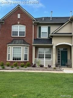 4412 Aster Blvd, Howell, MI 48843 - view of front facade with a front yard, brick siding, and covered porch