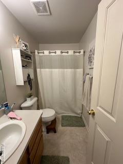 4412 Aster Blvd, Howell, MI 48843 - full bathroom featuring vanity, toilet, and a shower with shower curtain