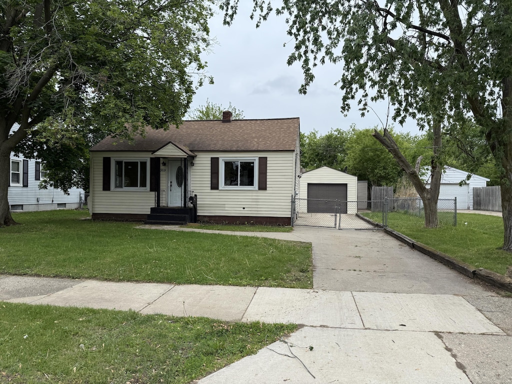 2909 W Ave SW, Wyoming, MI 49519 - bungalow featuring a detached garage, an outdoor structure, concrete driveway, a chimney, and a shingled roof