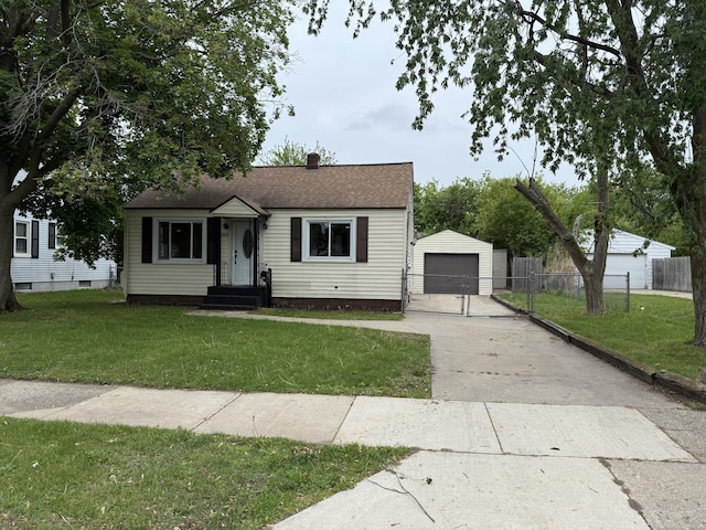 2909 W Ave SW, Wyoming, MI 49519 - bungalow featuring a detached garage, an outdoor structure, concrete driveway, a chimney, and a shingled roof