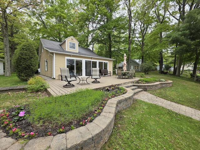 5022 N Ford Lake Rd, Fountain, MI 49410 - back of house featuring outdoor dining area, a deck, and a lawn
