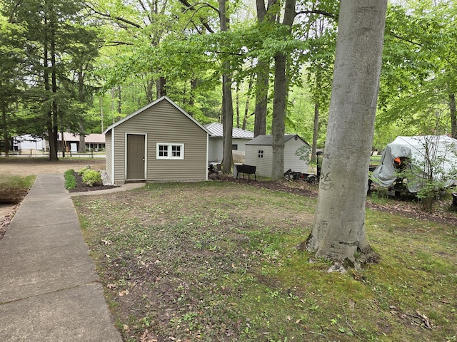 5022 N Ford Lake Rd, Fountain, MI 49410 - view of front of house with an outdoor structure and a shed