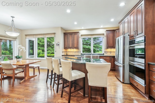 966 Mcdonald Dr, Northville, MI 48167 - kitchen with stainless steel appliances, plenty of natural light, tasteful backsplash, a center island, and recessed lighting