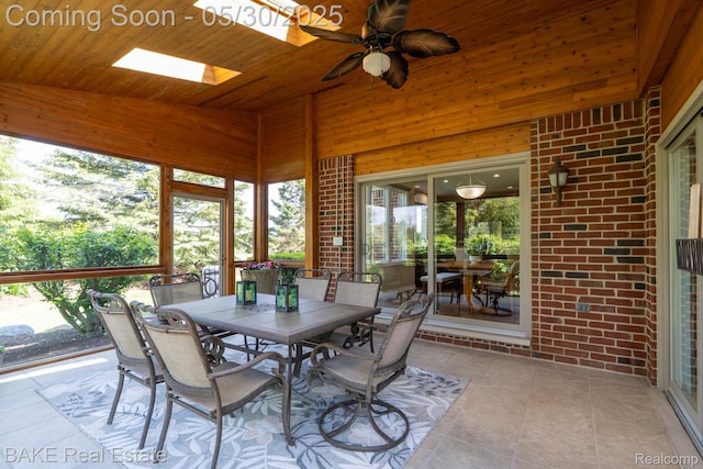 966 Mcdonald Dr, Northville, MI 48167 - sunroom featuring vaulted ceiling, outdoor dining area, a ceiling fan, and a skylight