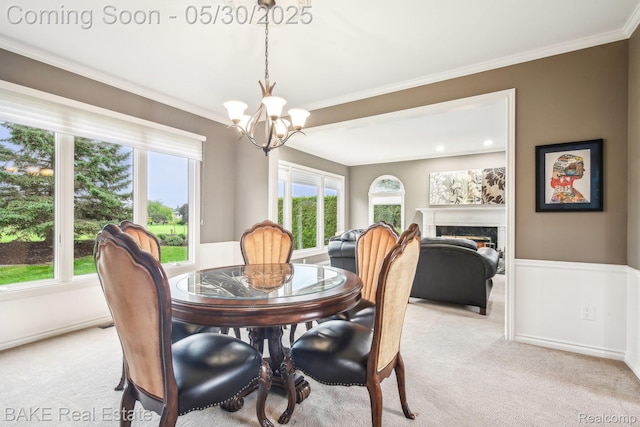 966 Mcdonald Dr, Northville, MI 48167 - dining space with a chandelier, light carpet, a premium fireplace, crown molding, and baseboards