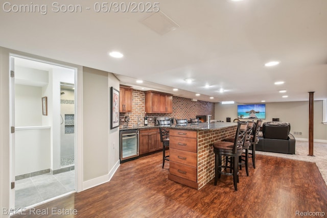 966 Mcdonald Dr, Northville, MI 48167 - kitchen with beverage cooler, a kitchen breakfast bar, brown cabinetry, a kitchen island, and dark wood-style flooring