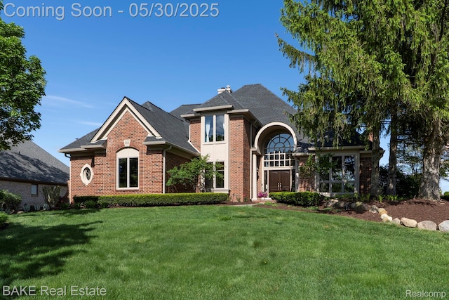 966 Mcdonald Dr, Northville, MI 48167 - view of front of house with brick siding, a front lawn, and a shingled roof