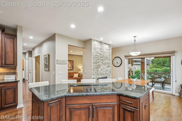 966 Mcdonald Dr, Northville, MI 48167 - kitchen with a sink, wood finished floors, a kitchen island, recessed lighting, and pendant lighting