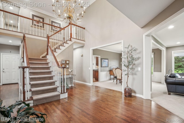 966 Mcdonald Dr, Northville, MI 48167 - entrance foyer with wood finished floors, ornamental molding, stairway, baseboards, and a chandelier