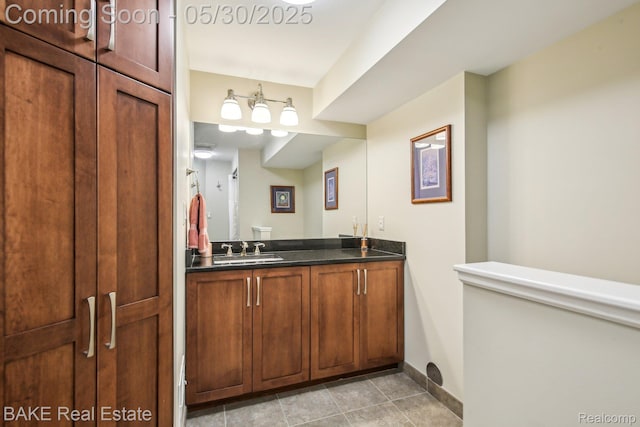 966 Mcdonald Dr, Northville, MI 48167 - bathroom with vanity, baseboards, and tile patterned floors