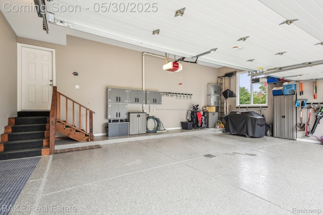 966 Mcdonald Dr, Northville, MI 48167 - garage featuring a garage door opener, a central vacuum unit, and baseboards