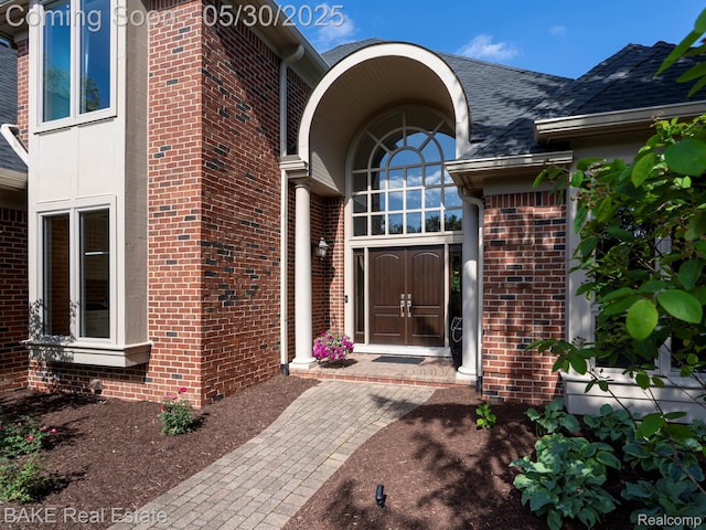 966 Mcdonald Dr, Northville, MI 48167 - property entrance with brick siding and roof with shingles