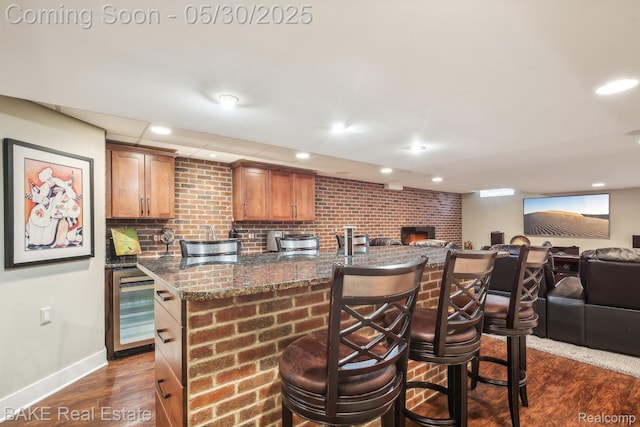 966 Mcdonald Dr, Northville, MI 48167 - kitchen with open floor plan, beverage cooler, a kitchen bar, baseboards, and recessed lighting