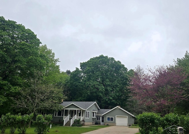 3775 N Hemlock Rd, Hemlock, MI 48626 - ranch-style house featuring an attached garage, concrete driveway, a front lawn, and covered porch