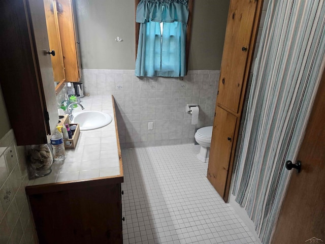 3775 N Hemlock Rd, Hemlock, MI 48626 - bathroom with tile walls, vanity, toilet, wainscoting, and tile patterned flooring