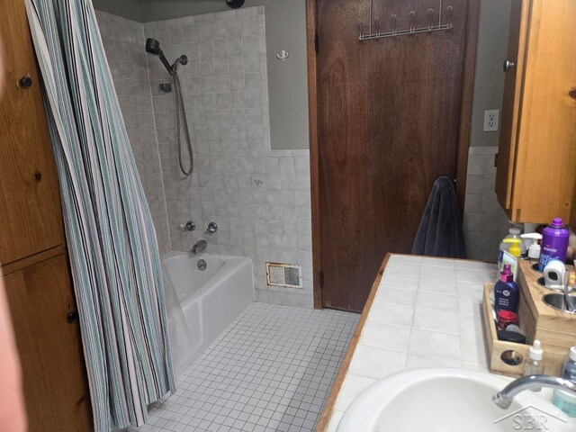 3775 N Hemlock Rd, Hemlock, MI 48626 - bathroom featuring a sink, shower / bath combo with shower curtain, and tile patterned flooring