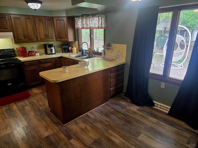 3775 N Hemlock Rd, Hemlock, MI 48626 - kitchen featuring black electric range, a sink, light countertops, a peninsula, and ventilation hood