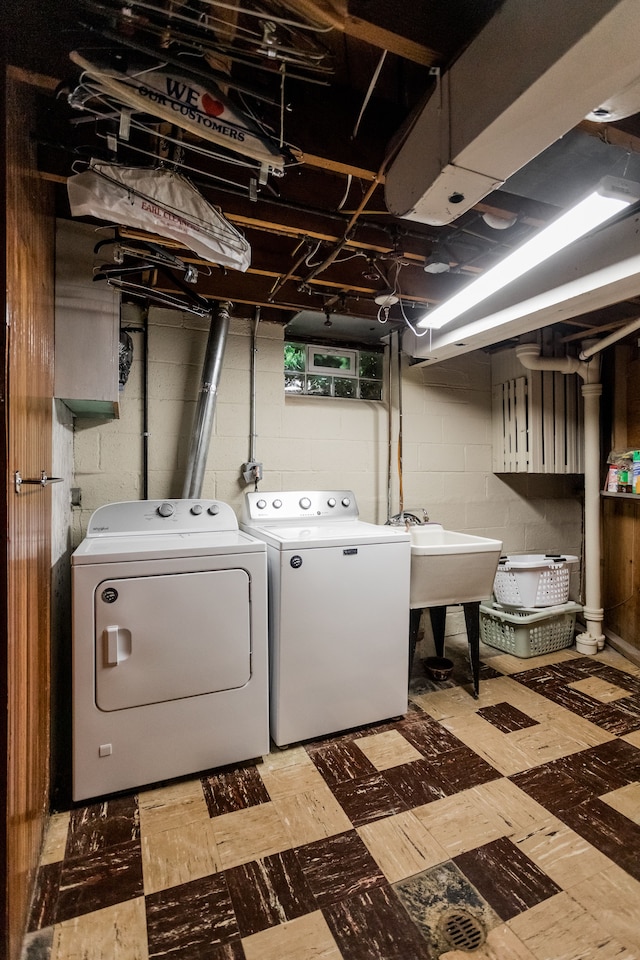 laundry area featuring washer and clothes dryer and light floors