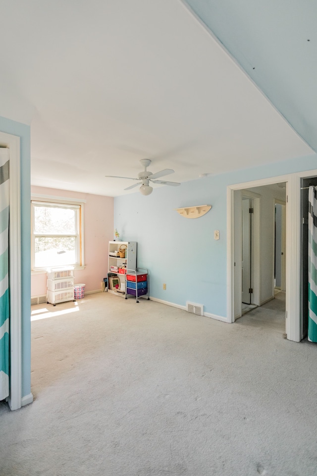 playroom featuring carpet flooring, a ceiling fan, and baseboards
