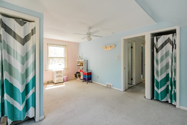playroom featuring carpet floors, ceiling fan, and baseboards