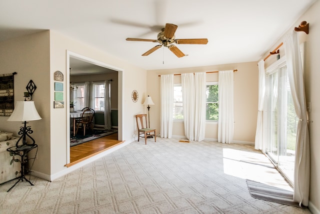 spare room with ceiling fan, carpet floors, and baseboards