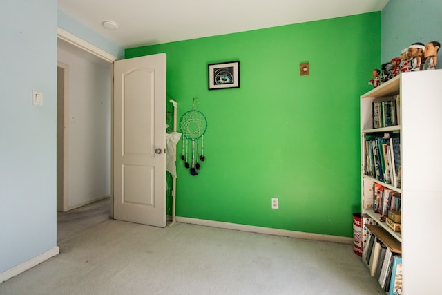 unfurnished bedroom featuring carpet and baseboards