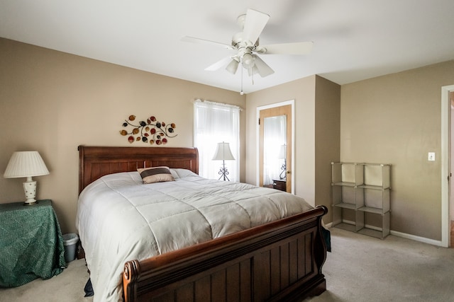 bedroom with light carpet, ceiling fan, and baseboards