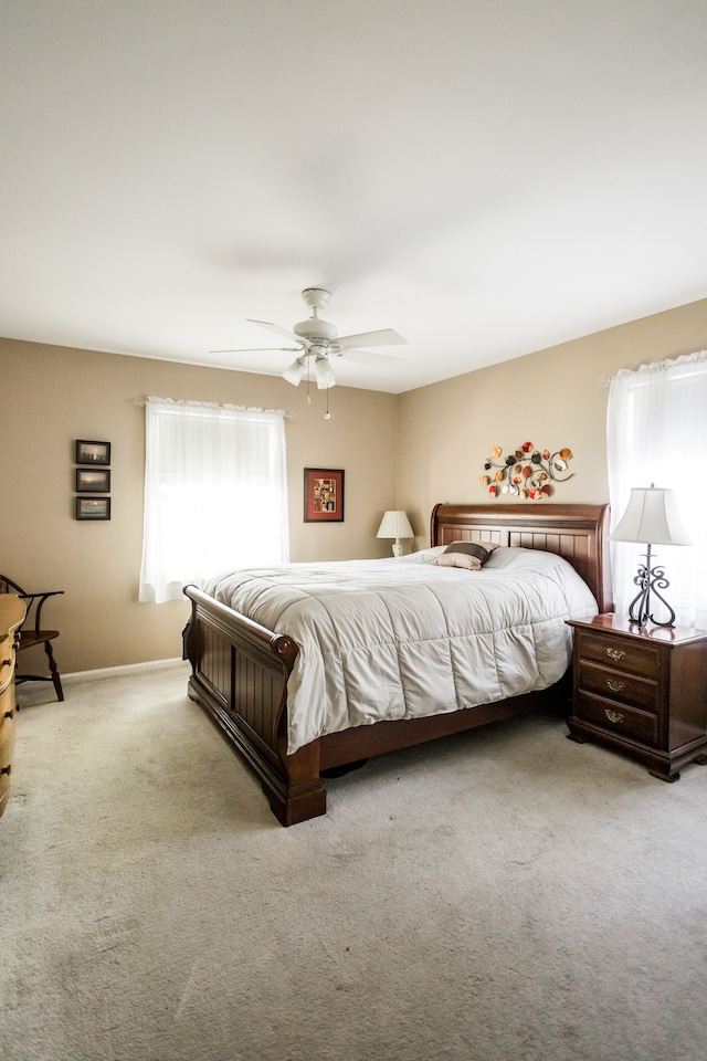 bedroom featuring carpet flooring, a ceiling fan, and baseboards