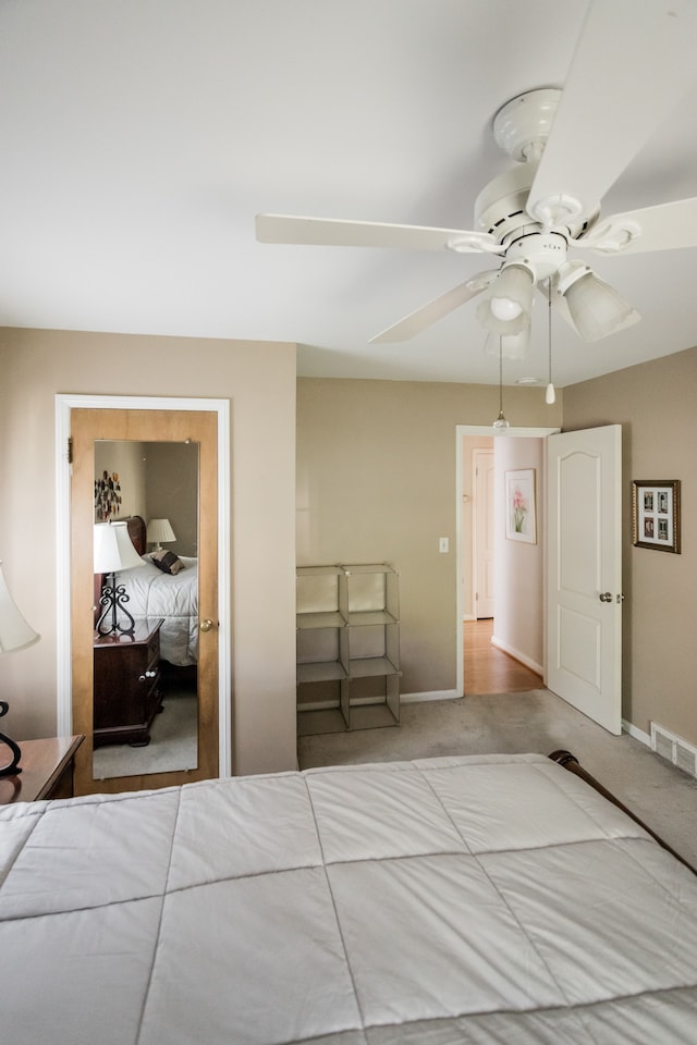 carpeted bedroom with baseboards and a ceiling fan