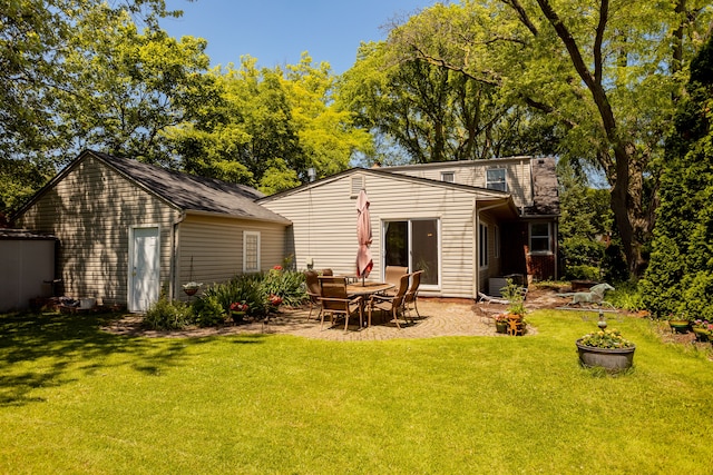 back of property featuring a lawn and a patio area