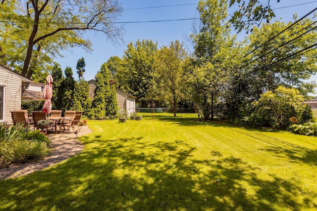 view of yard featuring an outbuilding and a patio area