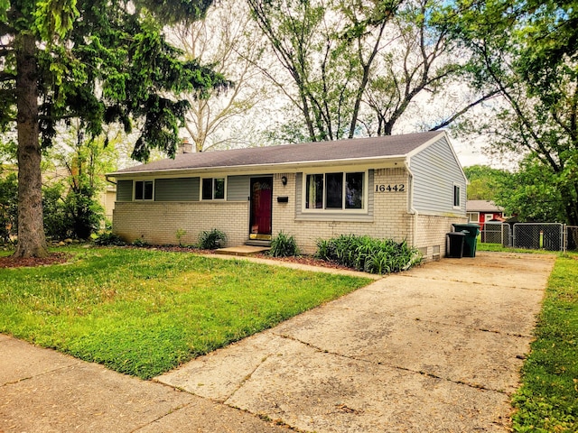 16442 Brandt St, Romulus, MI 48174 - view of front of house featuring brick siding, concrete driveway, a chimney, and a gate