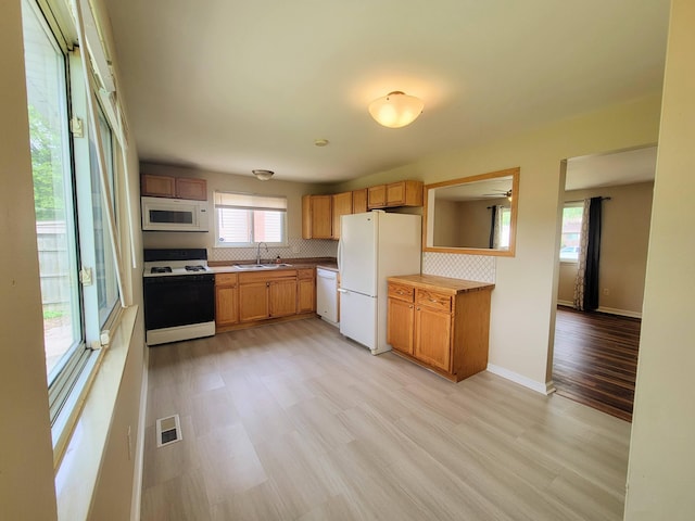 16442 Brandt St, Romulus, MI 48174 - kitchen with white appliances, a sink, healthy amount of natural light, and decorative backsplash