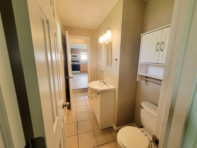 16442 Brandt St, Romulus, MI 48174 - bathroom featuring toilet, tile patterned floors, vanity, and baseboards