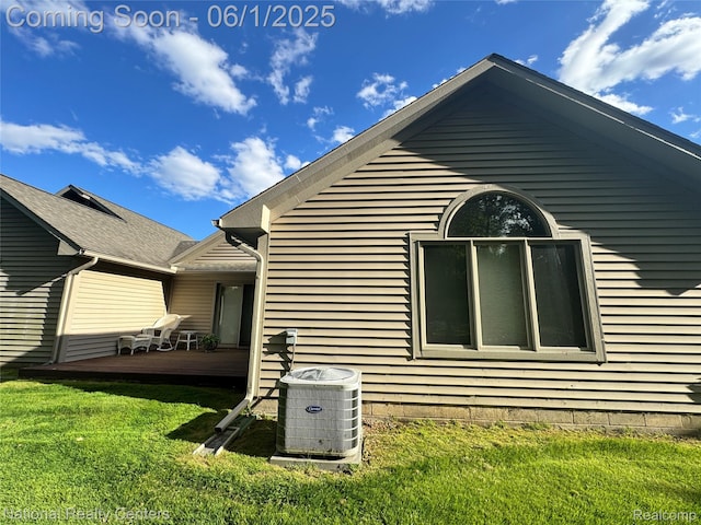 3052 Rivers Edge Dr, Wayne, MI 48184 - view of property exterior featuring central air condition unit, a deck, and a lawn