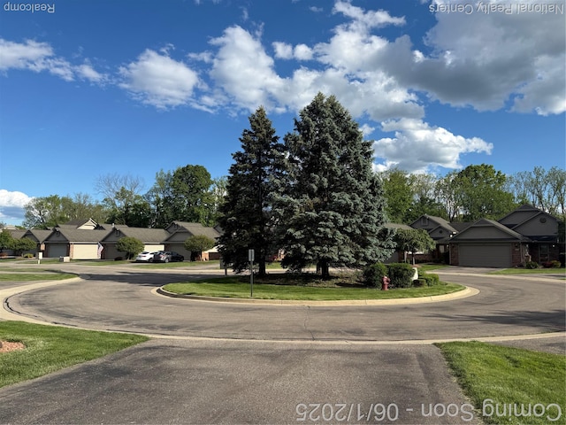 3052 Rivers Edge Dr, Wayne, MI 48184 - view of front of home with a residential view, curved driveway, and a garage