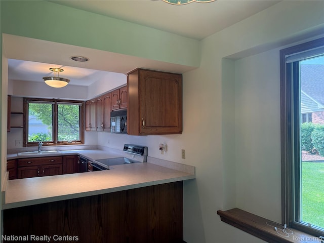 3052 Rivers Edge Dr, Wayne, MI 48184 - kitchen with black appliances, a sink, and healthy amount of natural light