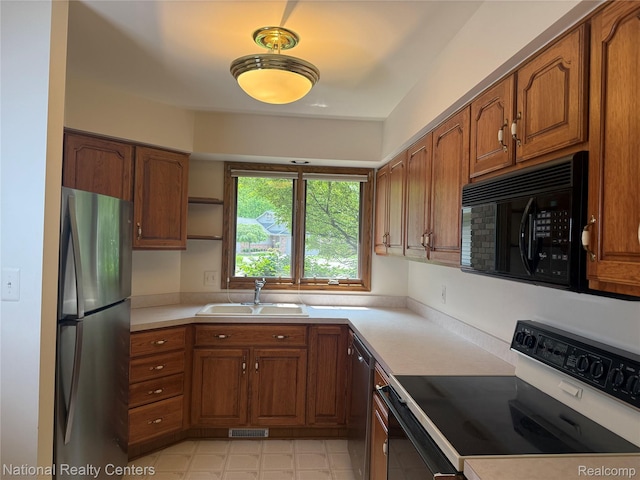3052 Rivers Edge Dr, Wayne, MI 48184 - kitchen featuring appliances with stainless steel finishes, a sink, brown cabinetry, light countertops, and open shelves