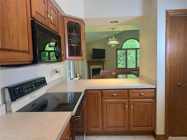 3052 Rivers Edge Dr, Wayne, MI 48184 - kitchen with black microwave, electric range, and brown cabinets
