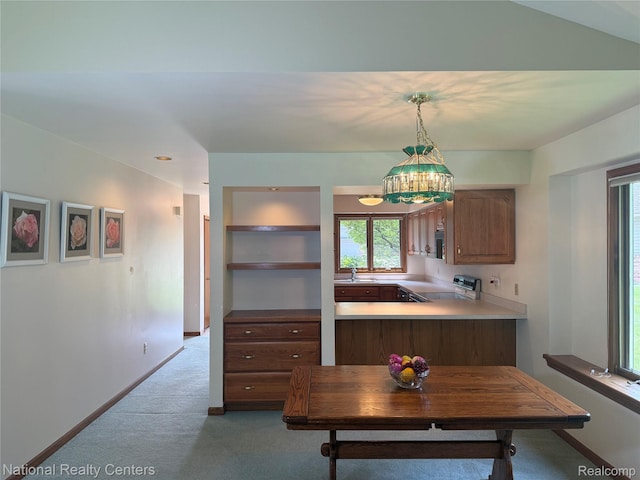 3052 Rivers Edge Dr, Wayne, MI 48184 - kitchen with range, light colored carpet, a sink, light countertops, and hanging light fixtures