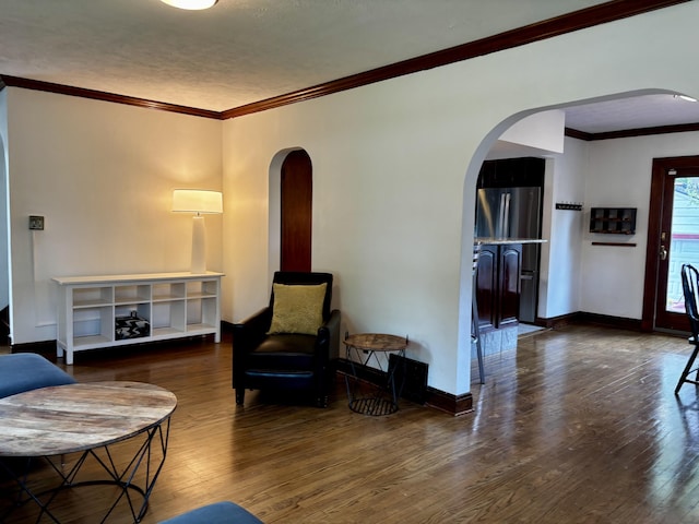 404 Pauline Blvd, Ann Arbor, MI 48103 - living room featuring arched walkways, hardwood / wood-style floors, ornamental molding, and baseboards